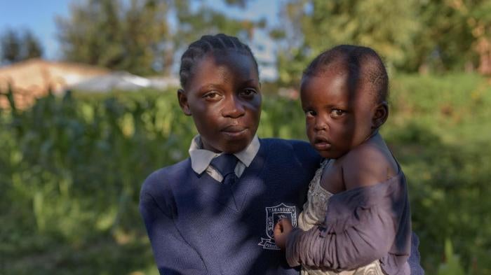 “Evelina,” 17, with her 3-year-old daughter “Hope,” in Migori county, western Kenya. Evelina is in Form 2, the second year of lower secondary school. 