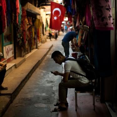 People check their phones at a market in central Istanbul, Türkiye, July 18, 2019.