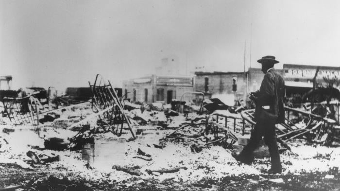 A man photographs the aftermath of the Tulsa Race Massacre on June 1, 1921. 