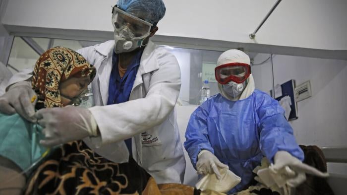 Medical workers attend to a Covid-19 patient in an intensive care unit at a hospital in Sanaa, Yemen, June 14, 2020. 