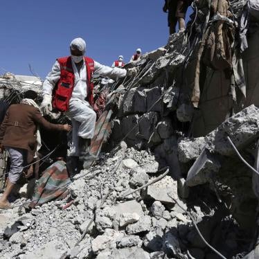 Rescue members remove rubble covering victims of aerial attacks carried out by the Saudi and UAE-led coalition.