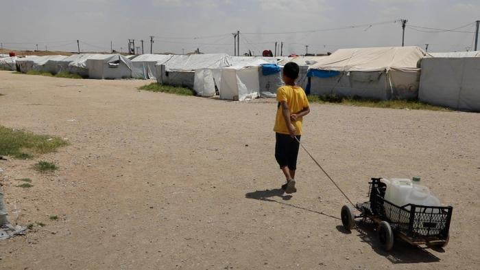 A boy drags a cart