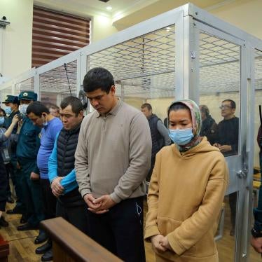 Defendants stand in a courtroom 