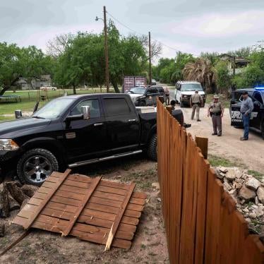 A truck shown after crashing through a wood fence 