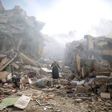 A resident walks amid the rubble of residential buildings after Israeli airstrikes in al-Zahra neighborhood in the Gaza Strip, October 19, 2023. 