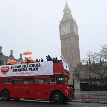 Protesters hold a banner on a red double decker bus 