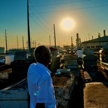 A man stands in a cemetery