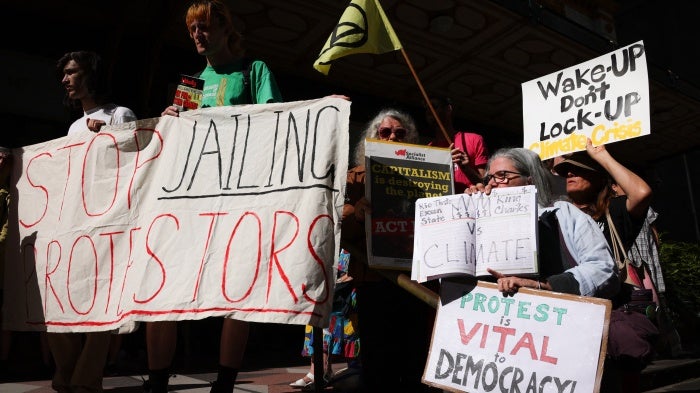 Protesters rally in support of climate activist Deanna "Violet" Coco, who was sentenced to jail for helping to block the Sydney Harbour Bridge, outside the Downing Centre court building in Sydney, Australia, December 13, 2022. 