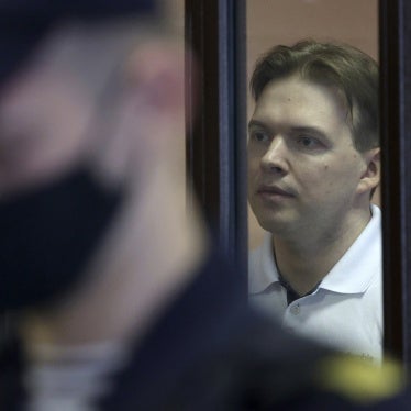 A man is shown behind bars in a courtroom