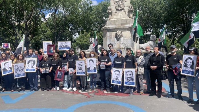 Victims’ and families’ associations gathered next to the Paris Criminal Court on May 21, 2024, holding photos of relatives who have been detained or disappeared in Syria. 