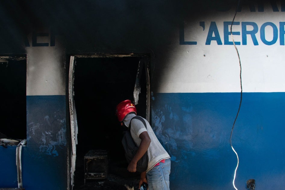 A man looks inside the burned police station "Commissariat de l'Aeroport" in Port-au-Prince, Haiti, March 5, 2024. 