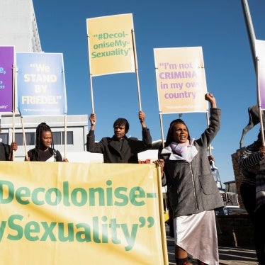 People hold banners in support of LGBTQ rights outside the high court which made a landmark ruling in favor of LGBTQ communities in Windhoek, Namibia, June 21, 2024.