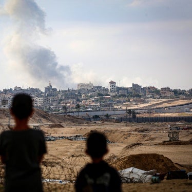 Children watch airstrikes east of Rafah in the southern Gaza Strip on May 13, 2024. 