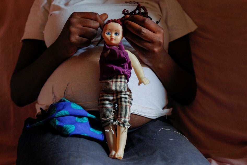 A secondary school student who is pregnant holds a doll inside her home in the Kibera slums of Nairobi, Kenya on September 30, 2020. (