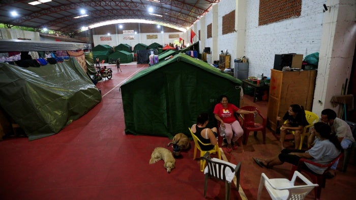 Displaced residents chat on a school court used as a temporary shelter after the Parana river overflowed its banks due to heavy rain upstream, in Ayolas, Paraguay November 8, 2023.