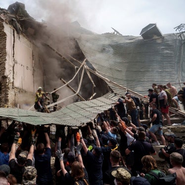 Workers remove debris from a destroyed hospital 