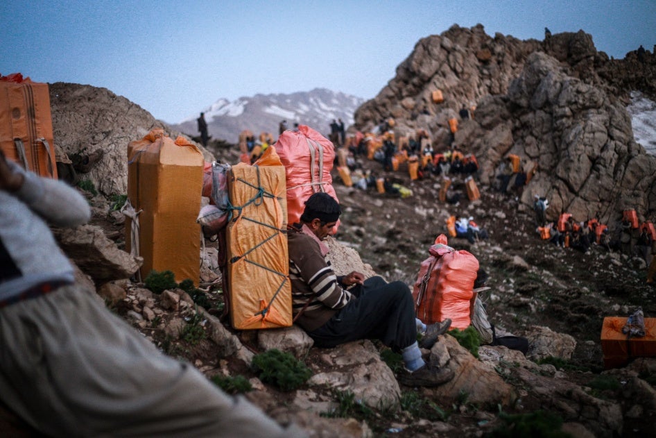 Kulbars carry goods on their backs along the mountains of the Iran-Iraq border, Kurdistan, Iran, April 29, 2017. 